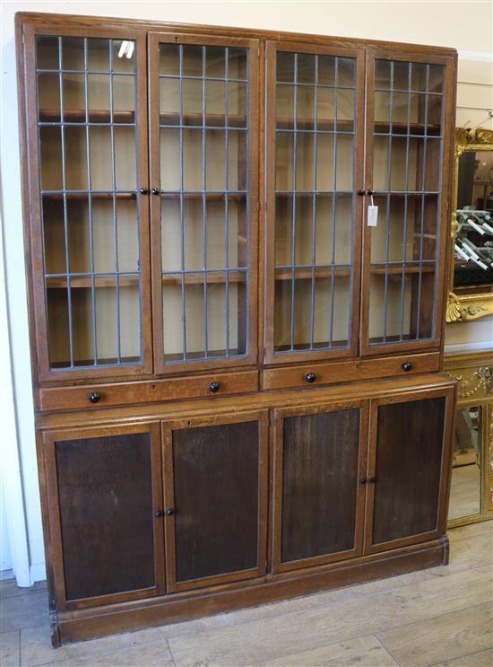 A 1920s oak library bookcase with leaded lights W.152cm